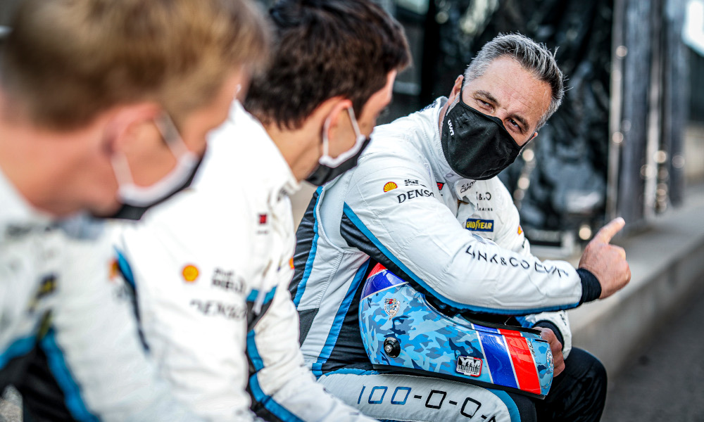 Yvan Muller wears a mask whilst talking to his team-mates