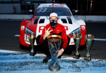 René Rast celebrates with his trophy whilst wearing a mask